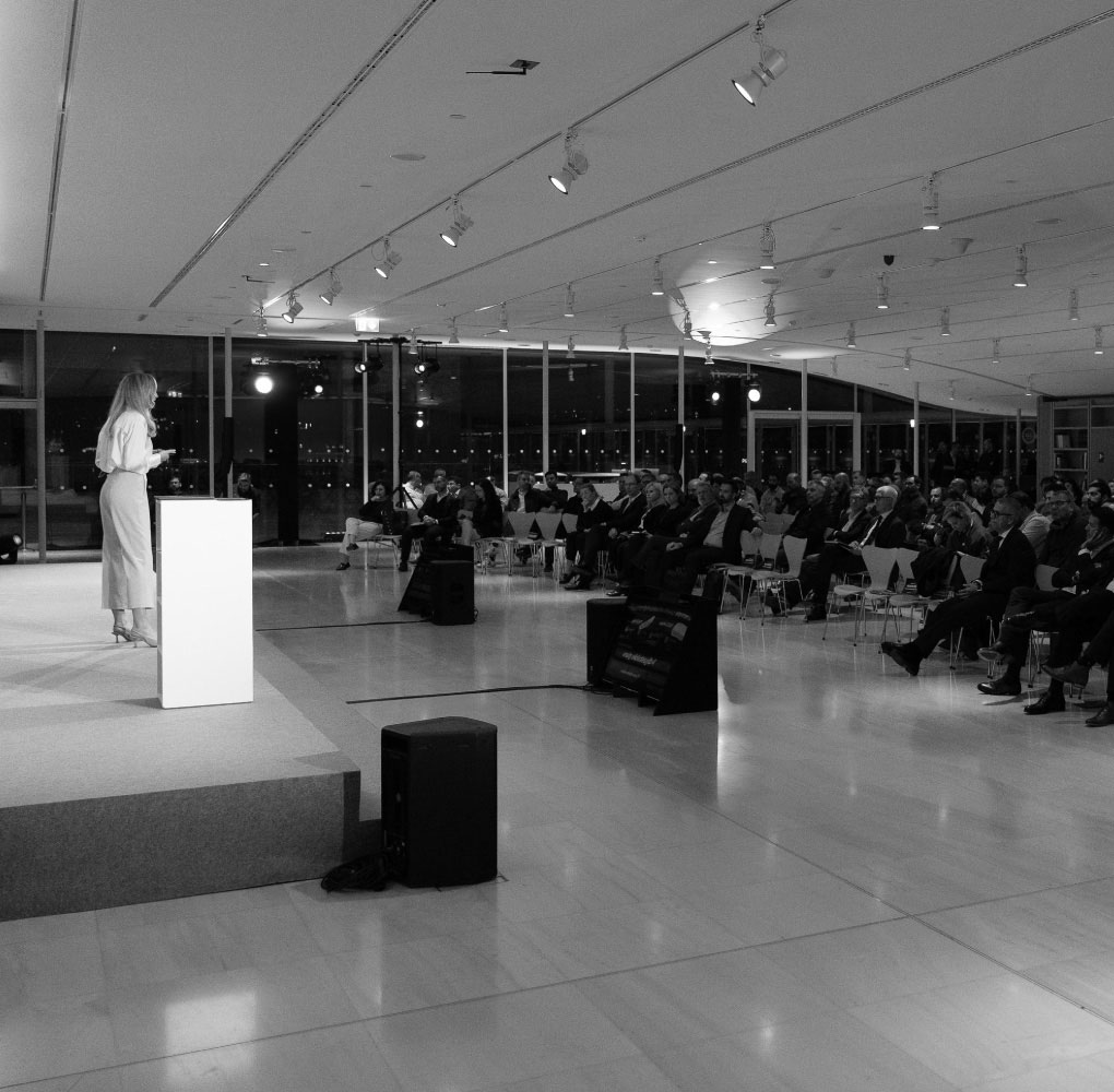 Black and white image showing a conference organized by Octopus Events.